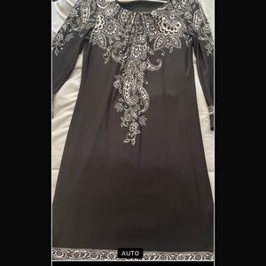 Size 10 black and white, knee length cocktail dress. Stretches, 3/4 sleeves